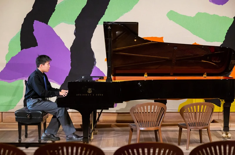Cameron Lu performing on a Steinway grand piano in the Utzon Room